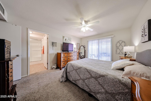 bedroom with a ceiling fan, carpet, visible vents, and a textured ceiling