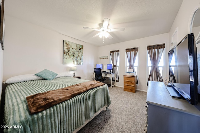 bedroom with light carpet, ceiling fan, a textured ceiling, and baseboards