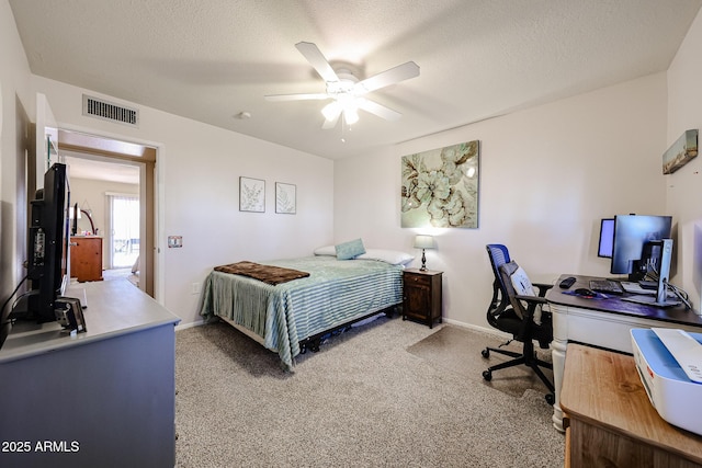 bedroom with carpet floors, visible vents, a textured ceiling, and baseboards