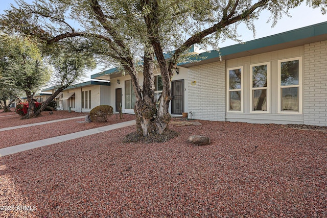 ranch-style house with brick siding