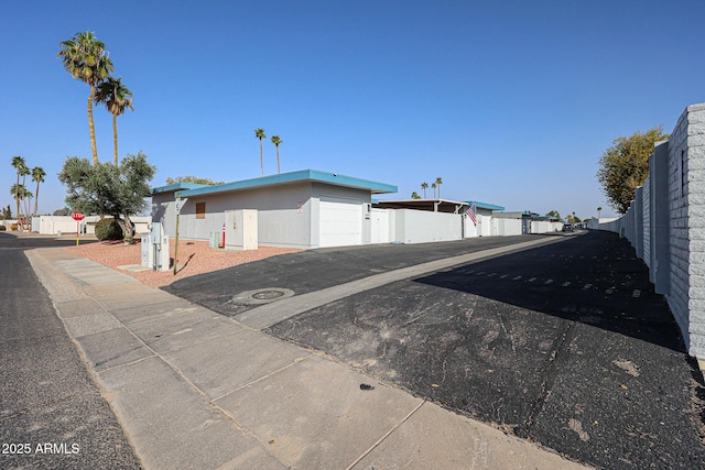 exterior space featuring a garage and fence