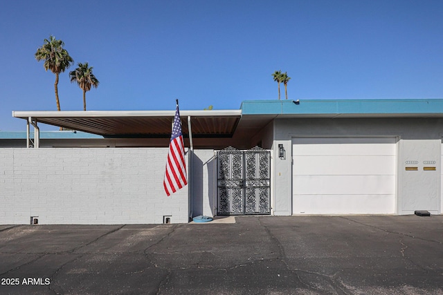 view of front of home featuring a garage, a gate, and fence