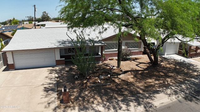 2432 W Echo Ln, Phoenix, AZ 85021 - view of front of house featuring driveway, brick siding, and a garage