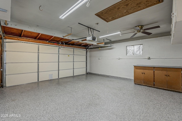 2432 W Echo Ln, Phoenix, AZ 85021 - garage featuring concrete block wall, a garage door opener, and a ceiling fan