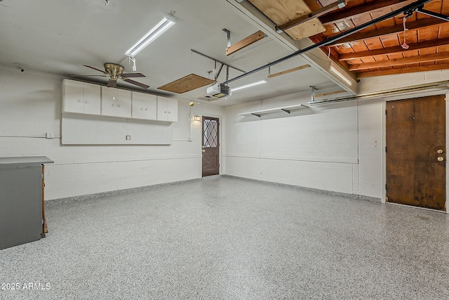 2432 W Echo Ln, Phoenix, AZ 85021 - garage featuring a garage door opener, concrete block wall, and ceiling fan
