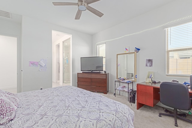 bedroom with light carpet, multiple windows, and ceiling fan