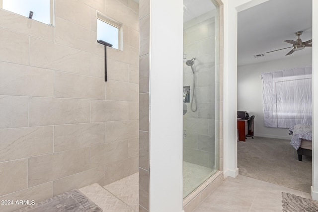 bathroom featuring a tile shower, ceiling fan, and tile patterned floors