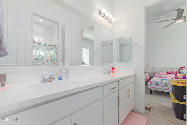 bathroom with ceiling fan, tile patterned flooring, and vanity