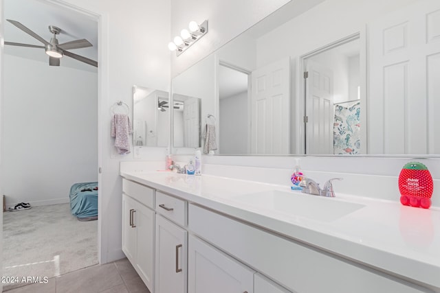 bathroom with tile patterned floors, vanity, and ceiling fan