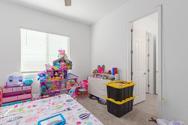 recreation room with ceiling fan and light carpet