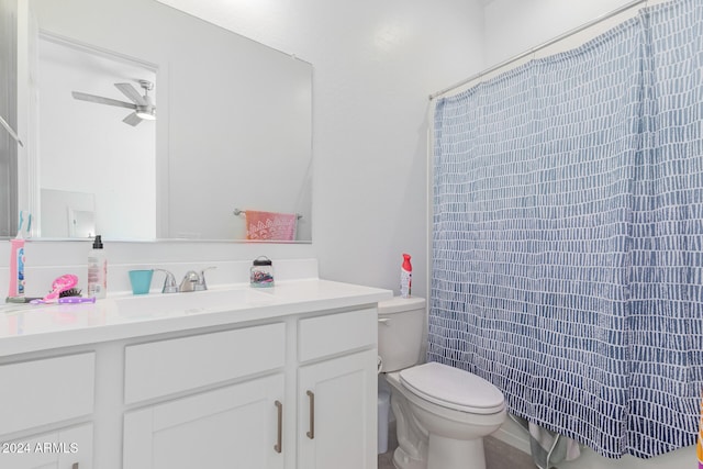 bathroom featuring ceiling fan, vanity, toilet, and curtained shower