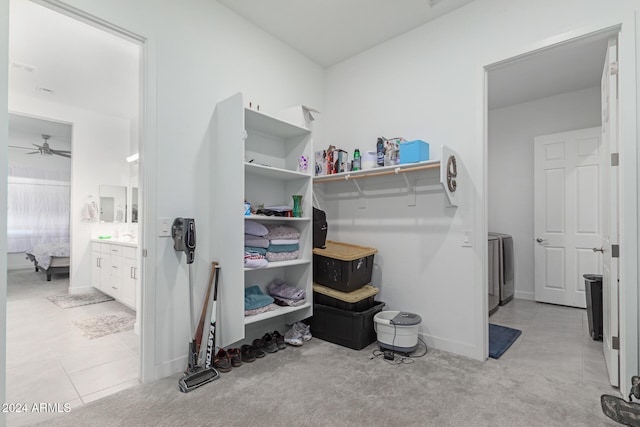 walk in closet featuring ceiling fan and light colored carpet