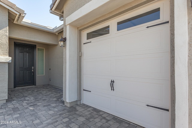 doorway to property with a garage