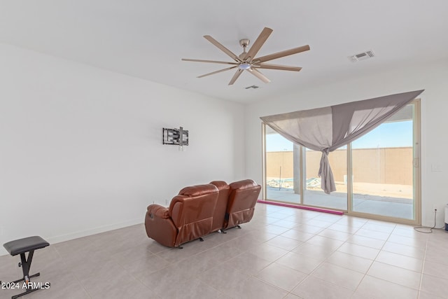 living area with ceiling fan and light tile patterned floors