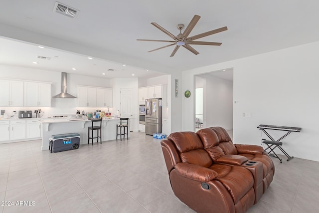 living room featuring ceiling fan and light tile patterned floors