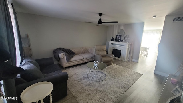 living room with hardwood / wood-style flooring and ceiling fan