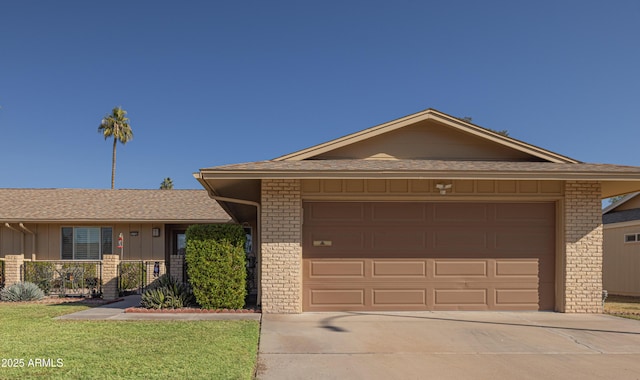 ranch-style home with a front lawn and a garage