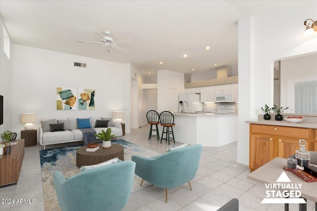 tiled living room with ceiling fan