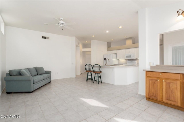 living room with ceiling fan and light tile flooring