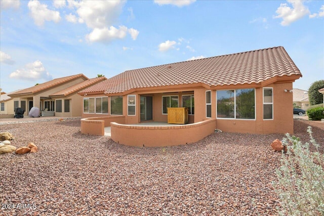 rear view of house featuring a patio