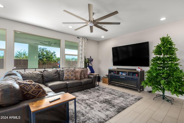 living room with light hardwood / wood-style floors and ceiling fan