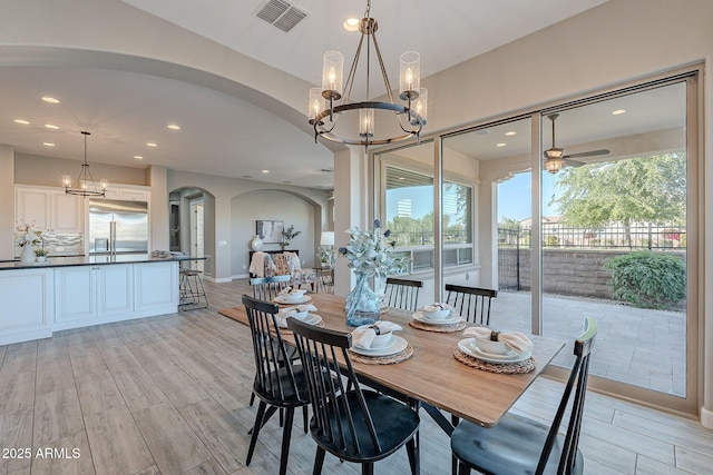 36169 N Serrano Ave, Queen Creek, AZ 85140 - dining area with recessed lighting, light wood-style flooring, visible vents, arched walkways, and ceiling fan with notable chandelier