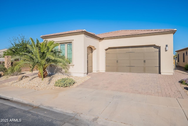 36169 N Serrano Ave, Queen Creek, AZ 85140 - view of front of property with a garage, driveway, a tiled roof, and stucco siding