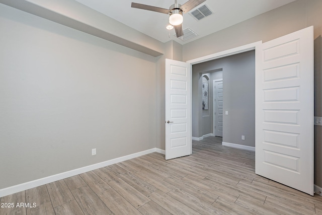 36169 N Serrano Ave, Queen Creek, AZ 85140 - unfurnished bedroom with light wood-style floors, baseboards, a ceiling fan, and visible vents