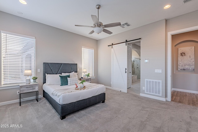 36169 N Serrano Ave, Queen Creek, AZ 85140 - bedroom with carpet floors, baseboards, visible vents, and a barn door