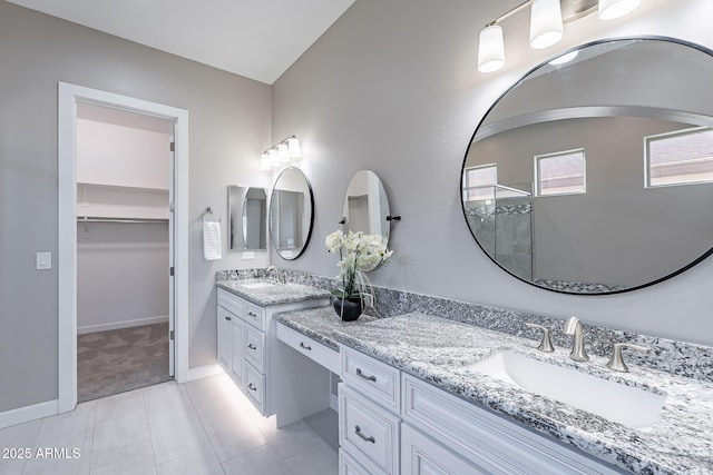 36169 N Serrano Ave, Queen Creek, AZ 85140 - bathroom with a walk in shower, vanity, tile patterned flooring, a spacious closet, and baseboards