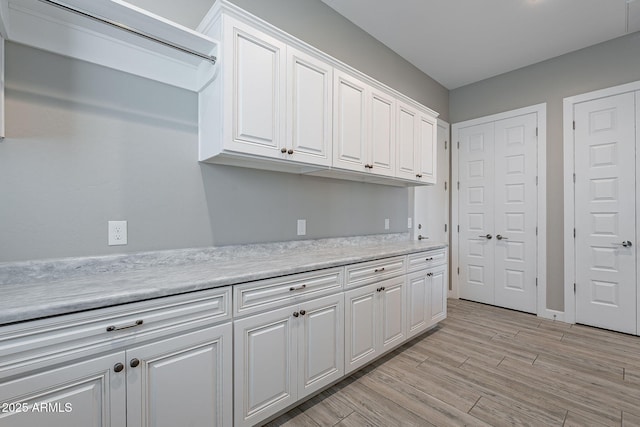 36169 N Serrano Ave, Queen Creek, AZ 85140 - kitchen featuring light wood finished floors, light countertops, and white cabinetry
