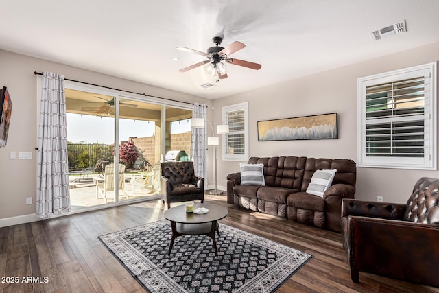 living room featuring dark hardwood / wood-style floors and ceiling fan