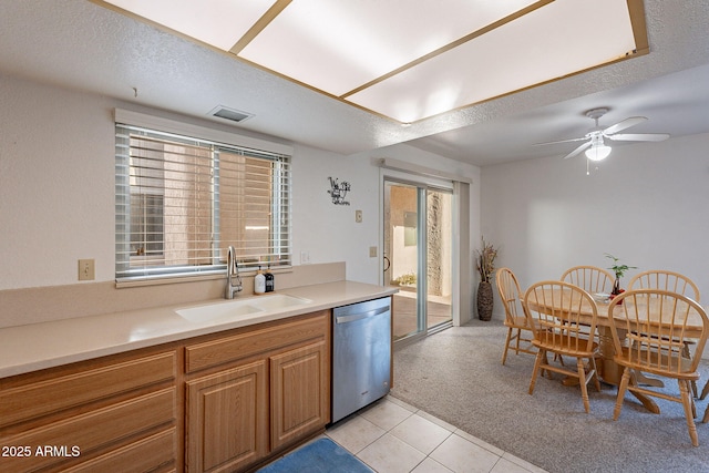 kitchen featuring sink, a textured ceiling, light tile patterned floors, stainless steel dishwasher, and ceiling fan