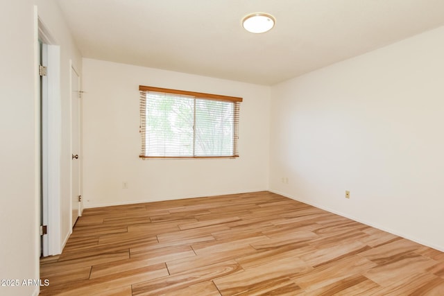 unfurnished room with light wood-style flooring