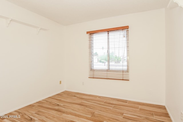 empty room with wood finished floors and baseboards