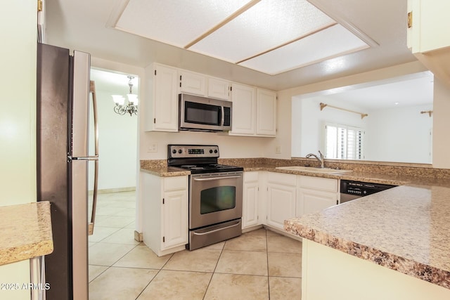 kitchen with stainless steel appliances, light countertops, white cabinetry, a sink, and light tile patterned flooring