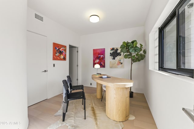 interior space with light wood-style floors and visible vents