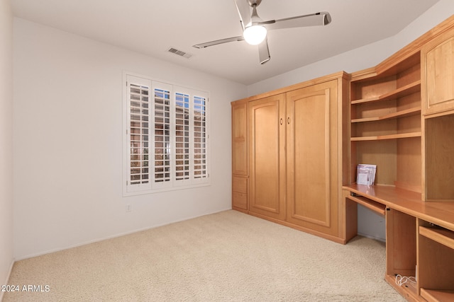 unfurnished bedroom with ceiling fan and light colored carpet