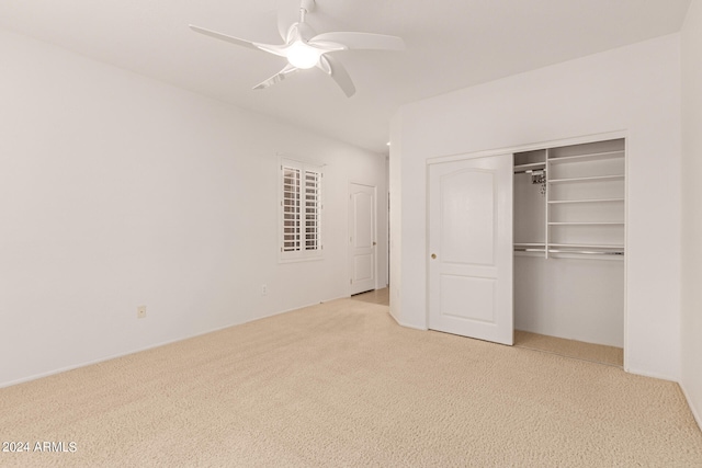 unfurnished bedroom featuring light carpet, ceiling fan, and a closet