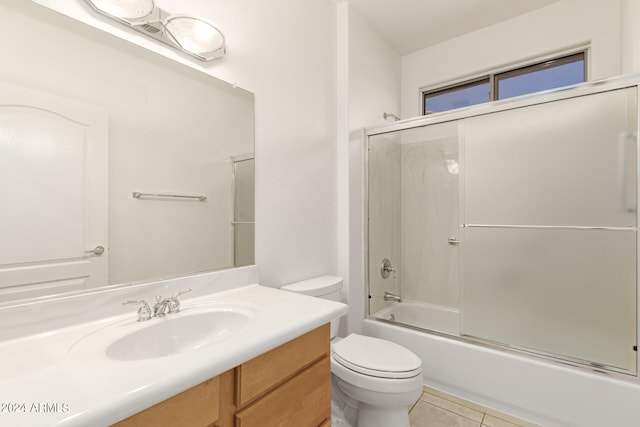 full bathroom featuring toilet, tile patterned flooring, vanity, and shower / bath combination with glass door