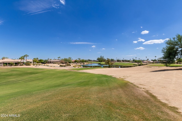 view of community with a water view and a yard