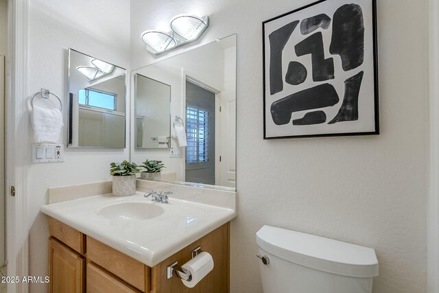 bathroom with toilet and vanity