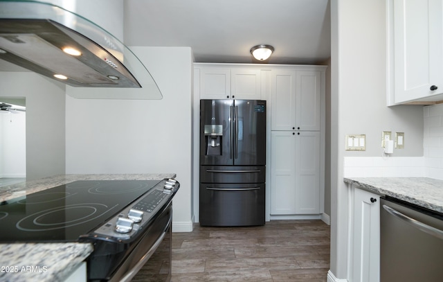 kitchen with electric range oven, island range hood, white cabinets, black fridge, and stainless steel dishwasher