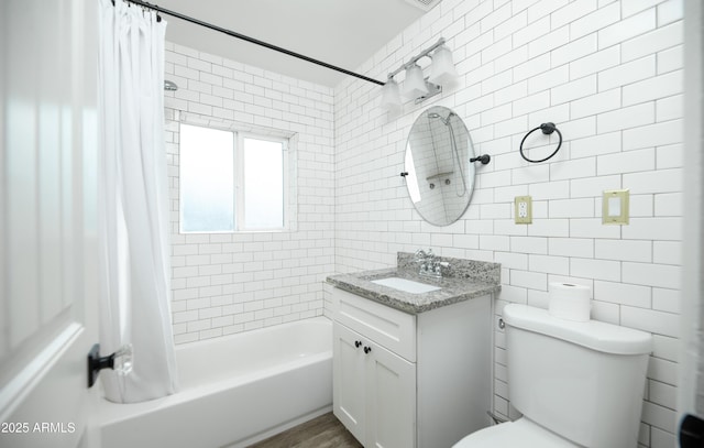 full bathroom featuring vanity, tile walls, shower / bathtub combination with curtain, and toilet