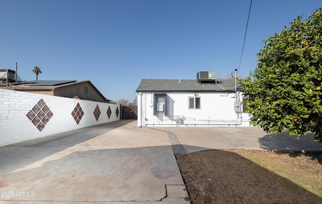 back of property featuring cooling unit and a patio