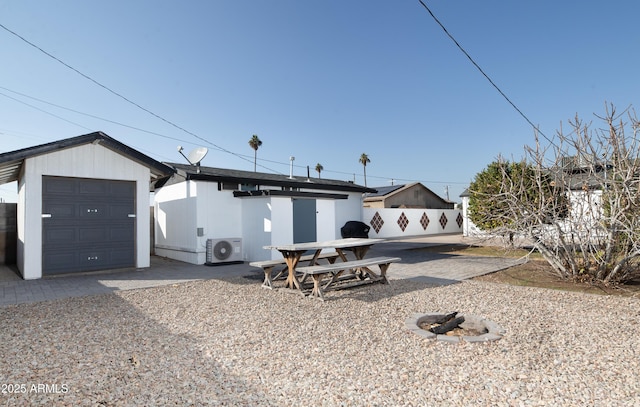 view of front of house featuring a garage and ac unit