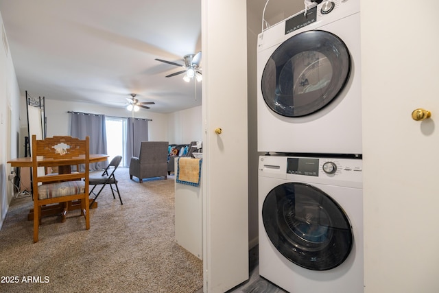 clothes washing area with laundry area, ceiling fan, stacked washing maching and dryer, and carpet