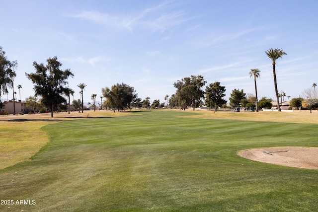 view of community with a yard and golf course view