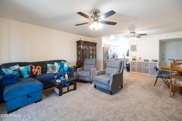 living room featuring light carpet, electric panel, and ceiling fan