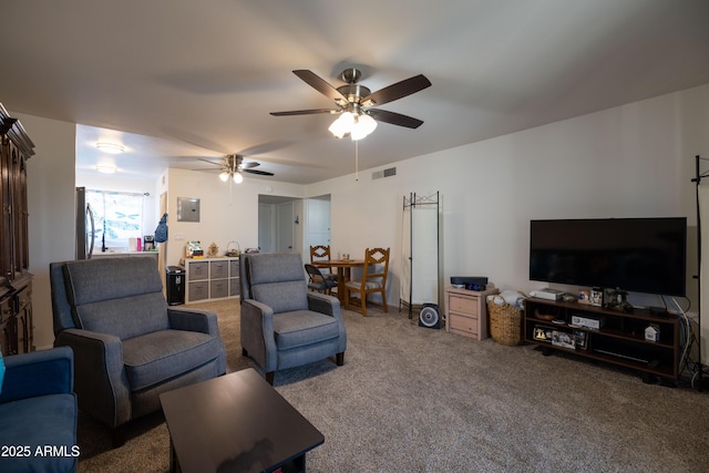 carpeted living room with electric panel, visible vents, and ceiling fan